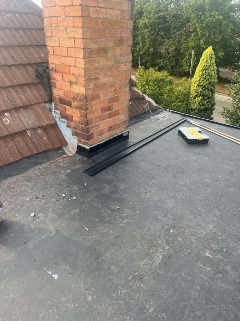 This is a photo of a flat roof which has just been repaired, there is also a chimney stack and some leadwork has also been dressed. Works carried out by Retford Roofing Repairs